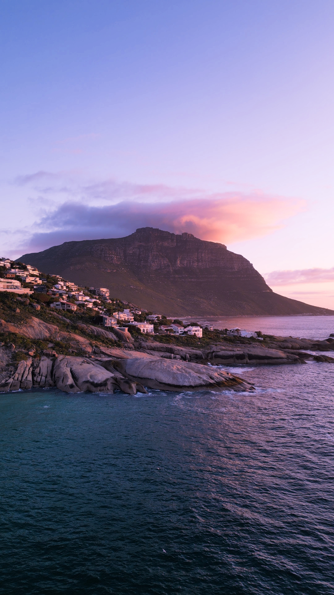 Coastal mountain glowing pink at sunset