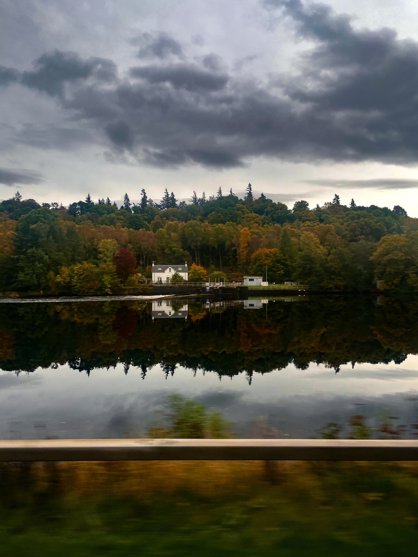 Autumn reflections on a still Scottish loch